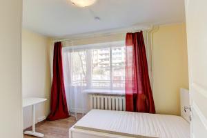 a bedroom with red curtains and a window at Oginskio st 5 Vilnius Students Home LT in Vilnius