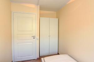 a bedroom with a white door and a closet at Oginskio st 5 Vilnius Students Home LT in Vilnius