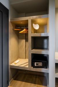 a walk in pantry with a clock in it at Nicolas Grand Suites, Adults Only in Kardamaina