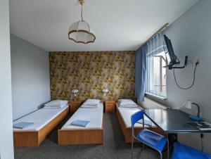 Łóżko lub łóżka w pokoju w obiekcie Motel DRABEK
