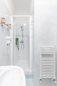 a white bathroom with a shower and a toilet at Hotel Espana - Gruppo BLAM HOTELS in Rome