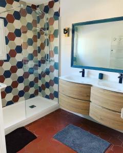 a bathroom with a shower and a tub and a sink at Les Palmiers in Le Muy