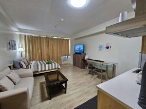 a living room with a couch and a table at N place at Soho Central in Manila