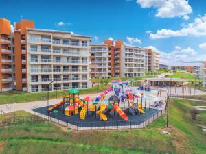 a park with a playground with slides and play equipment at Ilhas do Lago Eco Resort in Caldas Novas