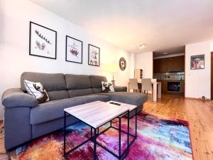 a living room with a couch and a table at Apartament Les 3 Valls in Llavorsí