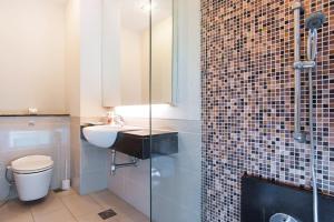 a bathroom with a toilet and a sink and a shower at Swiss Garden Residence Bukit Bintang in Kuala Lumpur