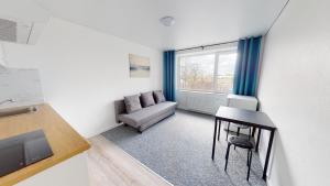 una pequeña sala de estar con sofá y mesa. en Kivi Apartments, en Jõhvi