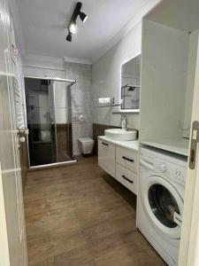 a bathroom with a washing machine and a sink at 140 m2 Size Ait in Çayirhisar