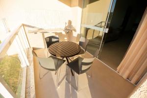 a room with a table and chairs on a balcony at Ilhas do Lago Eco Resort in Caldas Novas