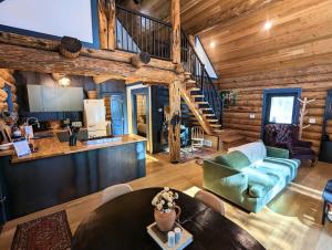 una sala de estar con una escalera en una cabaña de madera en Firefly Cabin en West Glacier