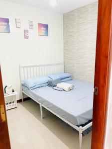 a bed in a small room with at D’Waldz Villa 2 Tagaytay in Tagaytay