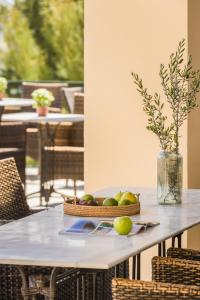 a table with a bowl of fruit on it at Griffon Kymi Hotel previously known as Valledi Village in Kymi