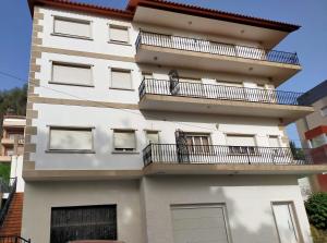 a white apartment building with a balcony at Playa en las Rías Baixas - Raxó in Raxo