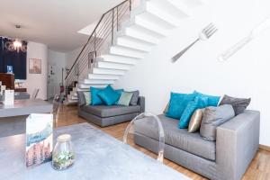 a living room with a couch and a staircase at Città Studi Suites - Top Collection in Milan