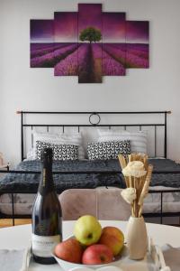 a bottle of wine and fruit on a table in a bedroom at Studio apartment Old Town Castle in Samobor