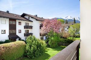 a house with a garden and mountains in the background at Berghex in Garmisch-Partenkirchen