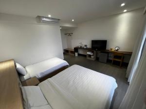Ein Bett oder Betten in einem Zimmer der Unterkunft One Roll Stone Homestay