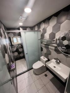 a bathroom with a toilet and a sink at One Roll Stone Homestay in Hung-pi-shou