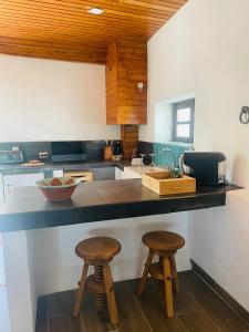 a kitchen with two stools and a counter top at Casa Pollard in Marvão