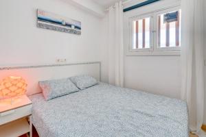 niewielka sypialnia z łóżkiem i oknem w obiekcie Parque Royal 1A255 w Adeje