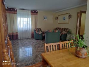 a living room with couches and a table at El Parangón in Herradón de Pinares