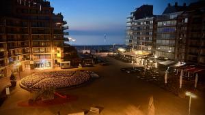 a view of a street at night with buildings at Appartement Seaview Bunnenplein in Knokke-Heist