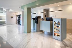 a store lobby with a counter and a refrigerator at B&B HOTEL Madrid Pinar de las Rozas in Las Rozas de Madrid