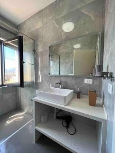 a bathroom with a sink and a mirror at Mozart House - Spacious Luxury Apartment - Heart of the City in Tirana