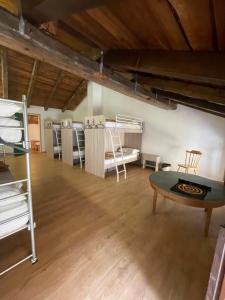 a room with bunk beds and a table in it at Casa delle Giuggiole in Dogna