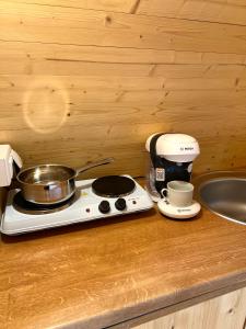 una encimera de cocina con fogones y una olla. en Gold Camping Seeboden, en Seeboden