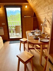 a dining room with a table and a window at Gold Camping Seeboden in Seeboden