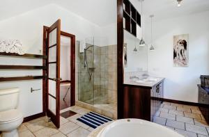 a bathroom with a shower and a toilet and a sink at Chalets Alpins- 10 Chemin des Montagnards in Stoneham +40 photos