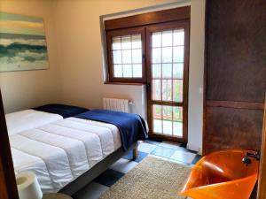 a bedroom with a bed and a window at Casuca El Trisquel - 18002 in Bareyo
