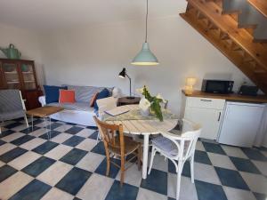 a kitchen and living room with a table and chairs at Casuca El Trisquel - 18002 in Bareyo