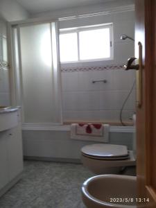 a bathroom with a toilet and a window at El Parangón in Herradón de Pinares +19 photos