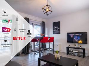 Televízia a/alebo spoločenská miestnosť v ubytovaní Le Nancy gare Hypercentre
