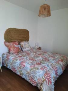 uma cama com um cobertor e almofadas num quarto em Sado House 2 na Comporta