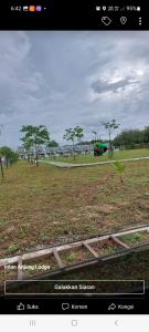 a screenshot of a picture of a park with trees at Homestay Intan Anjung Lodge in Malacca