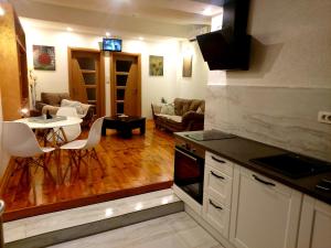 a kitchen and living room with a table and chairs at Apartmani vuk in Cetinje