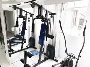 a gym with several tread machines in a room at The best location in Bogota in Bogotá