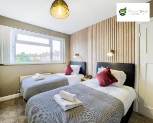 a hotel room with two beds and a window at Low rate Near Coventry College & Warwickshire Hospital -3 Bedroom house with Ensuite bathroom With free Netflix, Wi-fi, Parking & Garden, - DSC in Coventry
