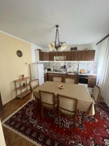 a kitchen with a table and chairs in a room at Sokobanja apartman Aviva in Soko Banja