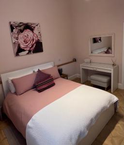 a bedroom with a bed and a table and a mirror at Penburren at Minster Farm West in Hereford