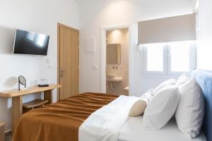 Posteľ alebo postele v izbe v ubytovaní Asimina Hotel