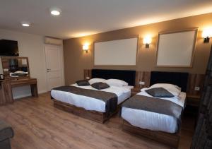 Voodi või voodid majutusasutuse Amber Hotel toas