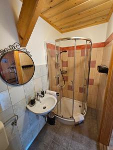 a bathroom with a shower and a sink at Koča na Taležu in Bled