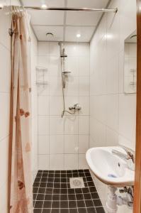 a white bathroom with a sink and a shower at Smolensko st 13 Vilnius Students Home LT in Vilnius