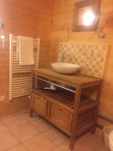 a bathroom with a sink in a wooden room at Chalet Pierre, Les Gets in Les Gets