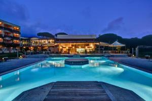 a large swimming pool in front of a building at Appartamento 4 posti letto n 238 presso Residence Golf Hotel Punta Ala in Punta Ala