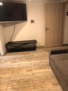 a living room with a large flat screen tv on the wall at precioso apartamento en el norte de armenia contiguo a SAO in Armenia